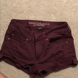 Ripped maroon jean shorts
